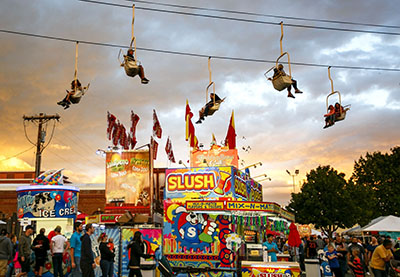 Fairgoers ride the FairLift ride over the fair