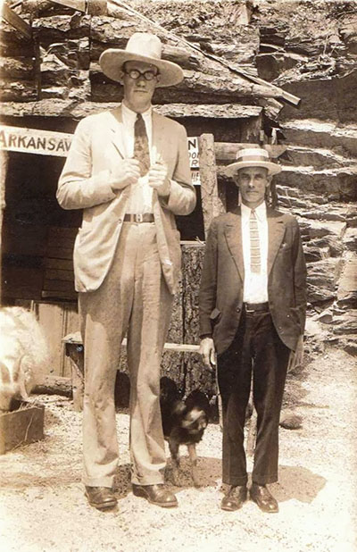 Giant man Clifford Thompson stand with a smaller man