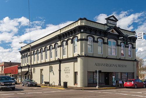 Two story building on a downtown city street.