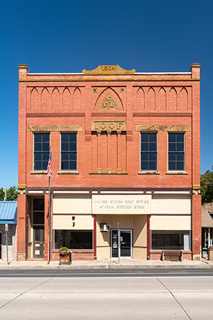 Two story brick building on downtown street.