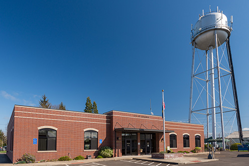 1 story brick building with a water tower to the side.