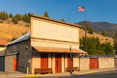 Building with false front commercial architecture. The sign over the top reads "Canyon City Brewery"