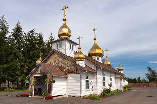 This Russian Orthodox Church has 5 gold plated onion-shaped domes. The front of the church displays frescos of religious nature.