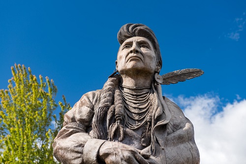 View looking up at the top half of a 14 ft. bronze statue of Chief Joseph of the Nez Perce.