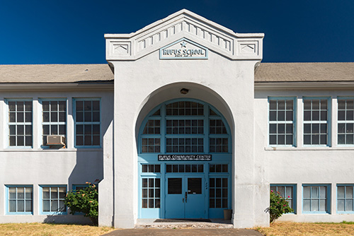 A two-story building with a central arched entrance labeled Bayview School above and Bayview Community Center on the doors below.