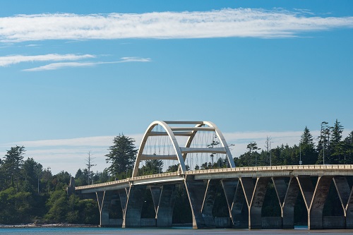 Concrete arch bridge spans Alsea Bay.