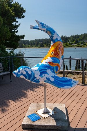 Sculpture of a sea lion brightly painted with waves and an octopus on the body.
