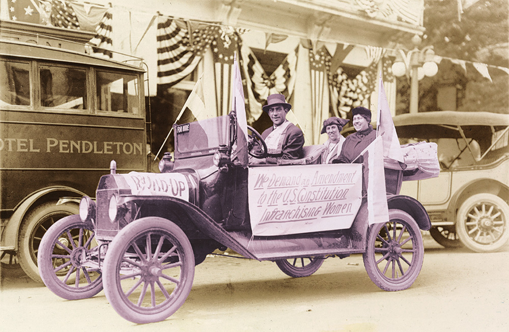 Margaret Whittemore and Mary Fendall ride in the back of a car driven by a man.