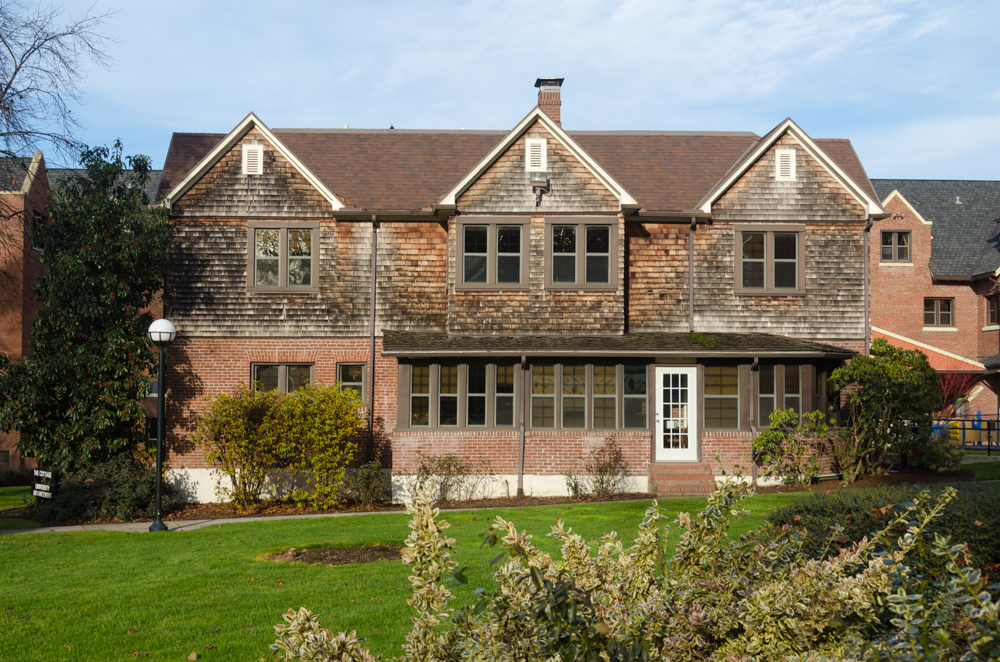 A historic two‑story brick building with a rectangular shape and evenly spaced tall windows.