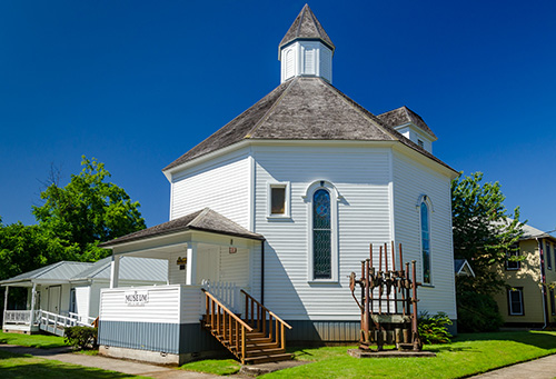 Octagonal building with stained glass wondows.