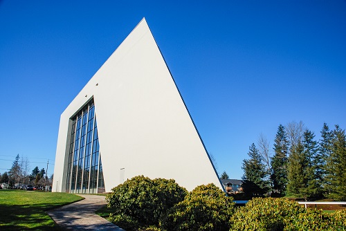 Exterior view of the four‑story Morrow Crane Building at 3218 Pringle Road SE, Salem, Oregon—an office structure built in 1984 with a light‑colored masonry and glass façade.