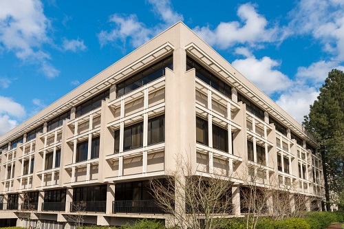 Front façade of the Agriculture Building in Salem, a two‑story, light‑colored government building with a central entrance framed by columns.