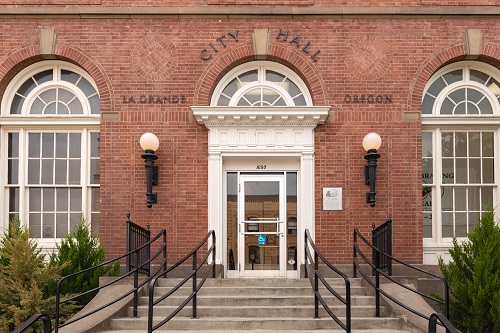The front door of La Grande city hall. The building is brick.
