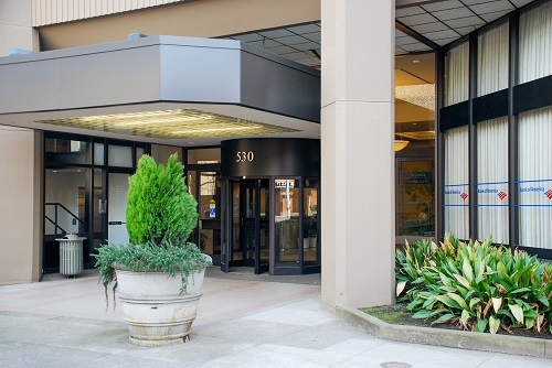 Exterior view of a low-rise commercial building in downtown Salem, Oregon, housing the central offices of the Board of Chiropractic Examiners