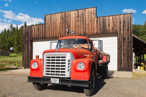 Old west style building with an International brand fire truck in front.