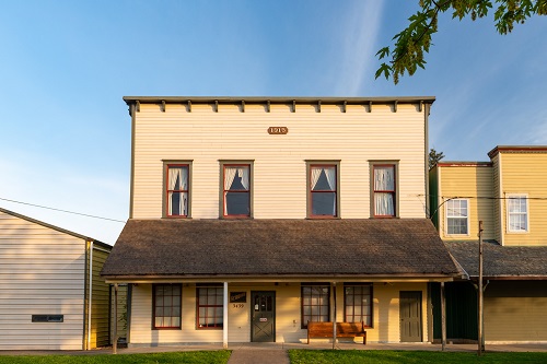 Historic storefront building in downtown Hubbard with a wood‑clad facade, large display windows, and a simple painted sign above the entrance.