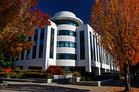 The Barbara Roberts Human Services Building in Salem—a 1992 modernist government office structure with a white façade, large horizontal bands of green‑tinted windows, and clean-lined, functional design