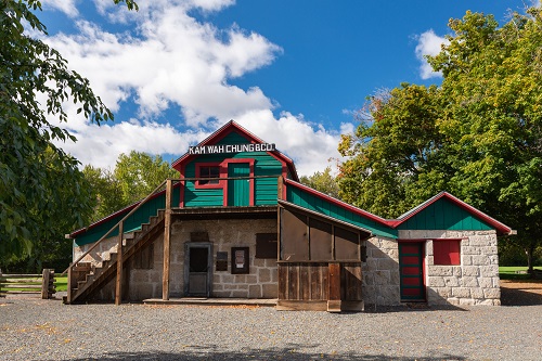 Wood and stone building that served as trading post. Two stories with stairs on the outside that lead to top level.