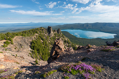 View of a lake from a high mountain peak.