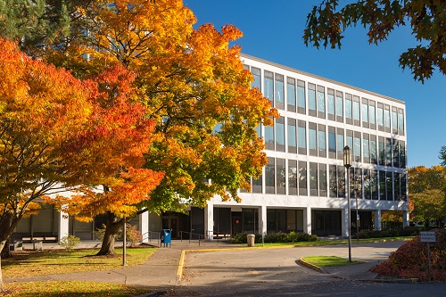 A modern, multi-story white government building with large rectangular windows, identified as the Labor and Industries Building