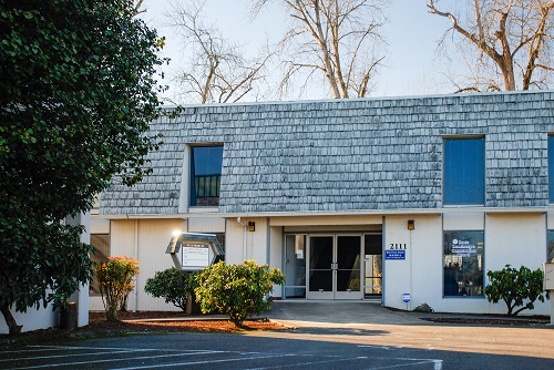 Exterior view of a low‑rise government office building.