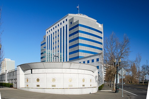 800 NE Oregon St is a distinct, largely concrete-and-glass, institutional-style office building.