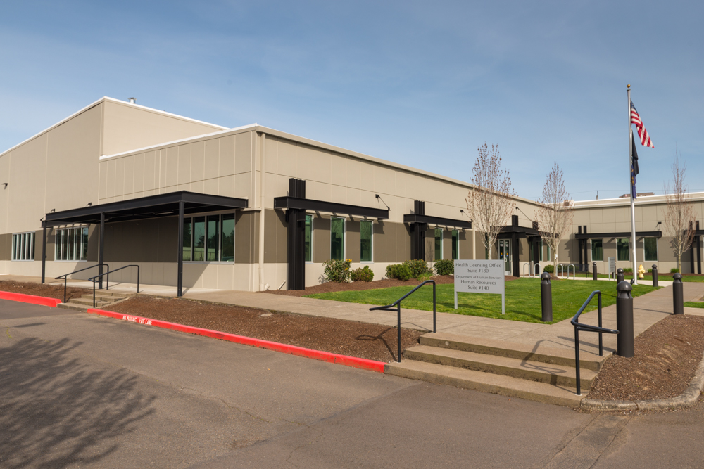 Single‑story, rectangular office building at 1321 Tandem  Ave in Salem—a light‑colored, modern commercial structure with large windows along its facade.