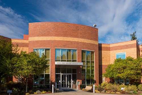 a two‑story, modern office building set amid landscaped grounds, housing the central offices of PERS.