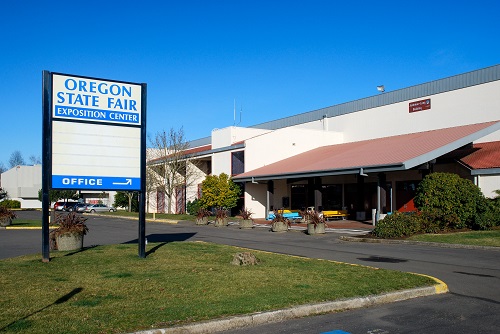 Single story office building with a sign in front reading Oregon State Fair Exposition Center