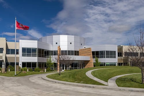 a modern single-story stone and wood building set amid open grounds on the Confederated Tribes of the Umatilla Indian Reservation at Whitehorse