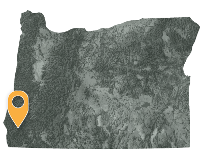 Map with a pointer showing the location of Confederated Tribes of Coos, Lower Umpqua and Siuslaw in southwest section of Oregon