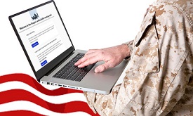 A person in military dress holds a laptop showing the screen for accessing military and overseas ballots online.