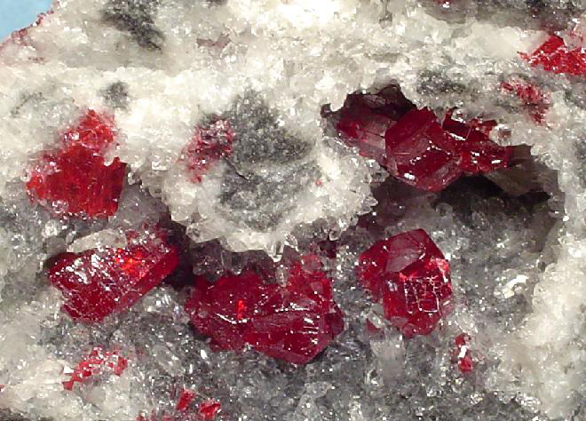 Contrasting red cinnabar stones embedded in quartz sparkles. 