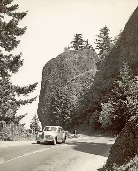 The highway curves around a large domed rock known as Bishop's Cap or Mushroom Rock.