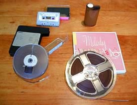 Several forms of audio storage shown such as cassette tapes and dictation tape from the 1960s.