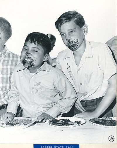 Two boys at a pie eating contest