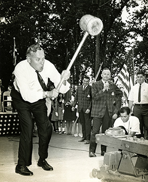 Governor Tom McCall swings a mallet the State Fair