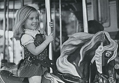 A girl rides the merry-go-round
