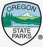 Oregon State Parks shield with drawing of mountain and trees in center