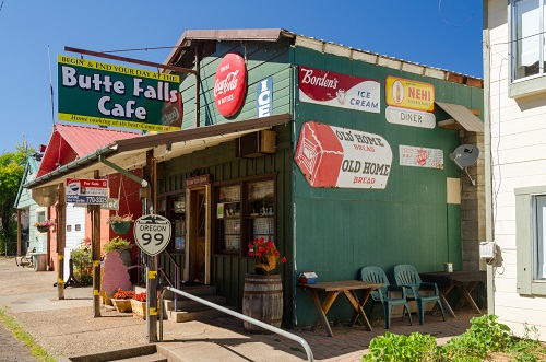 Butte Falls Cafe (now closed) displayed colorful product signs on the the building: Old Home Bread, Borden's Ice Cream