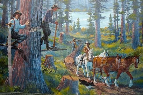 Colorful mural of early logging techniques used in the Sandy area. Men with horses & long saws in the forest.