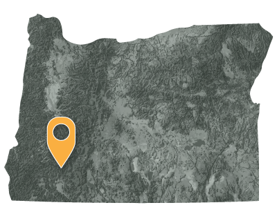 Oregon map with black and white circles documenting location of the Cow Creek Band